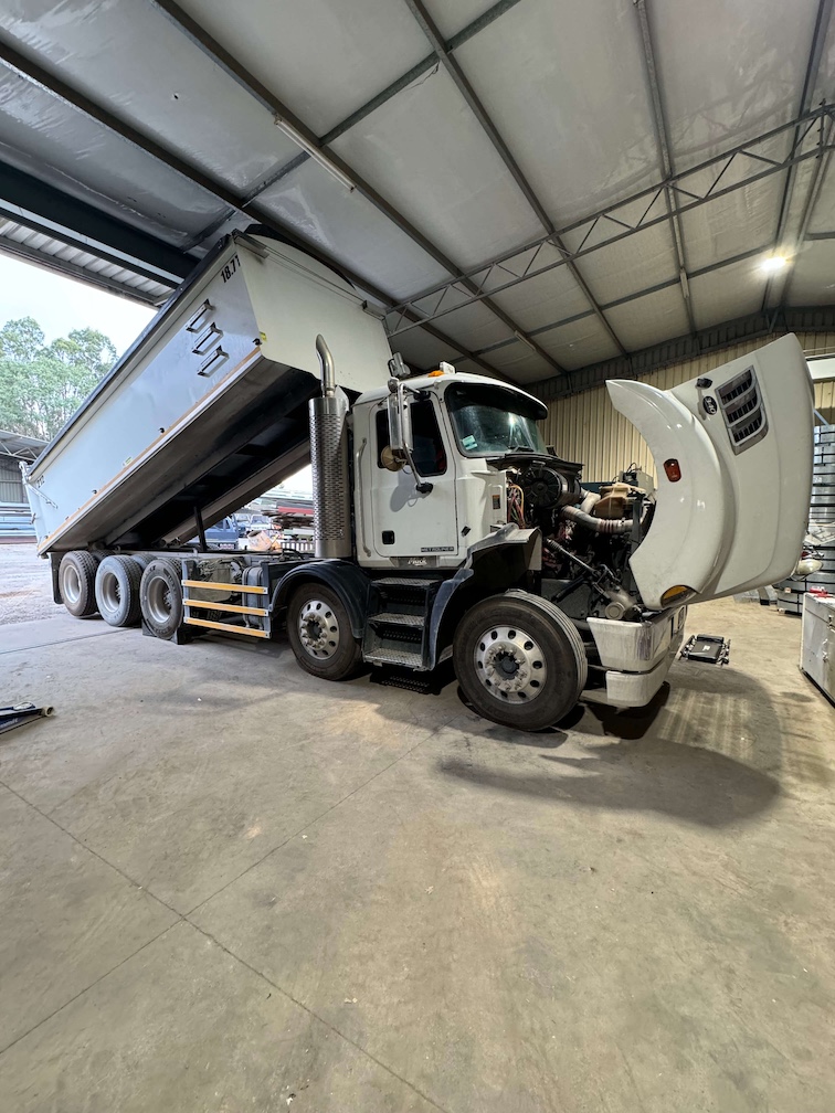 Tipper with cab tilted for engine and hydraulic work