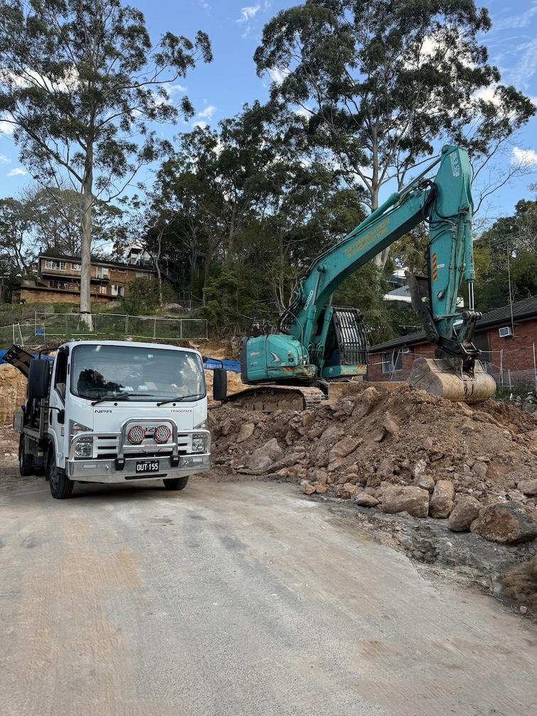 Light truck and excavator on a civil earthworks site