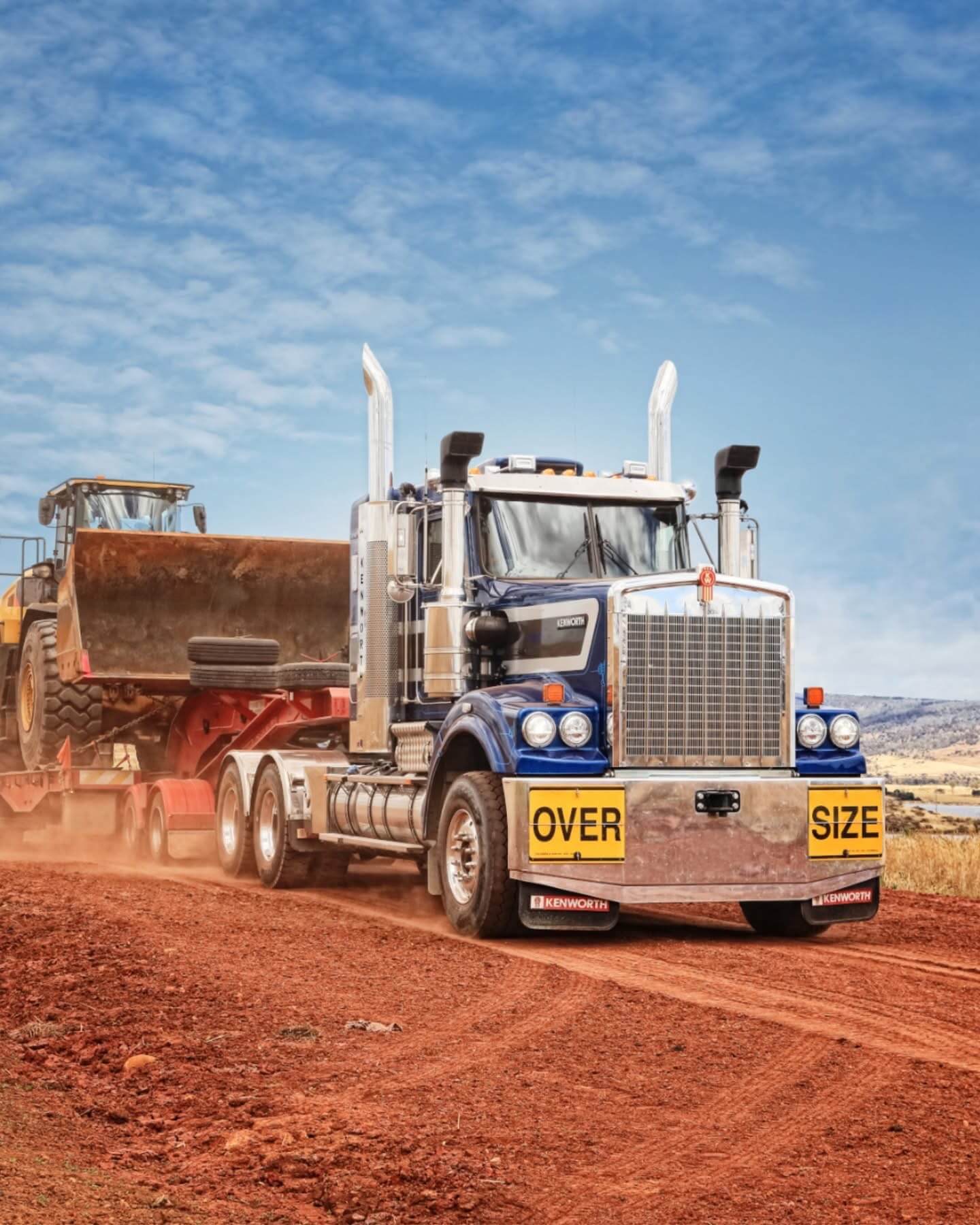 Prime mover hauling earthmoving plant on a regional run